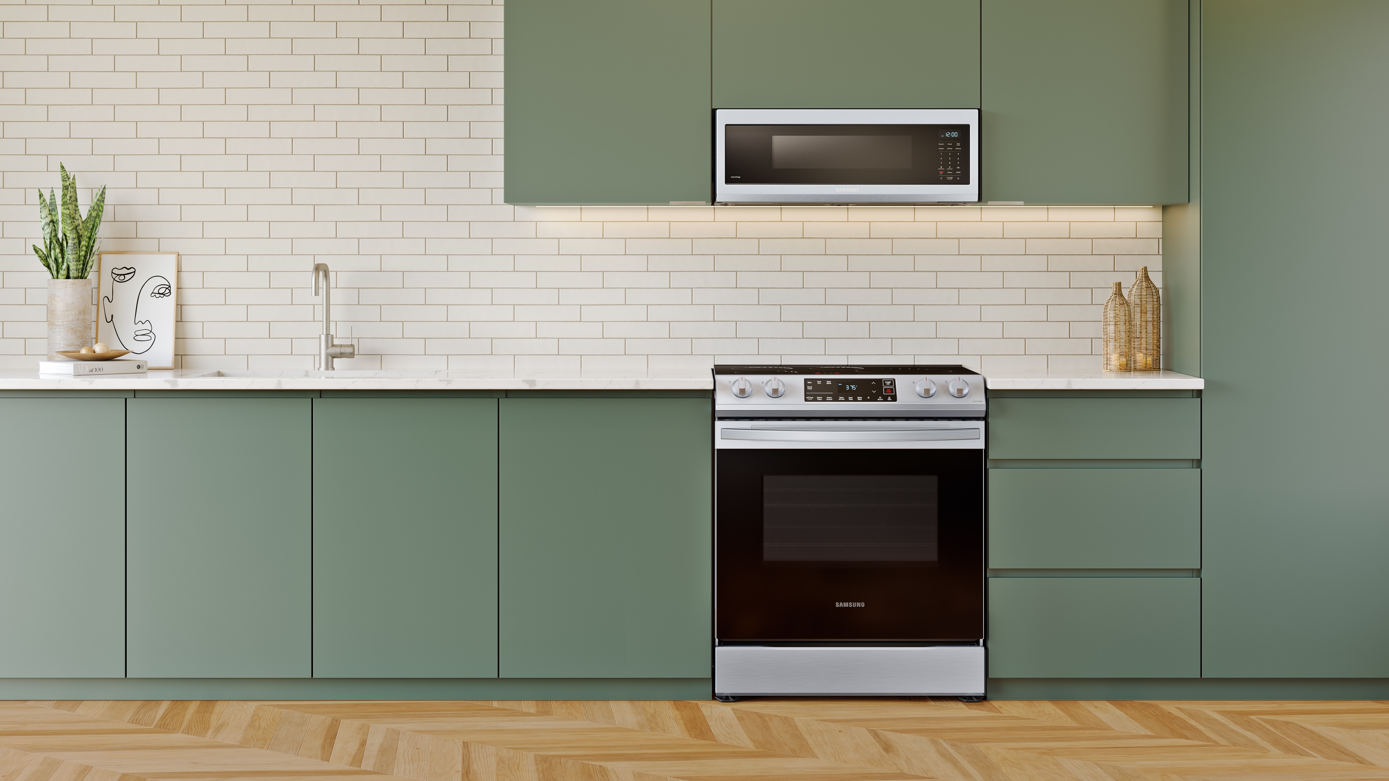 Samsung NE63B8211SS stainless steel electric range installed in modern kitchen with sage green cabinets, white subway tile backsplash, and matching stainless steel over-the-range microwave.